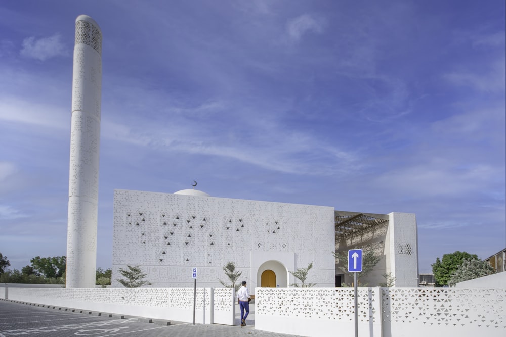 a man standing in front of a white building