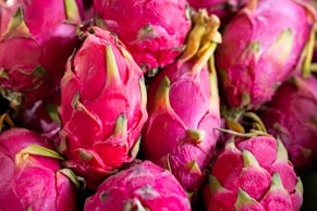 a pile of pink dragon fruit sitting on top of a table