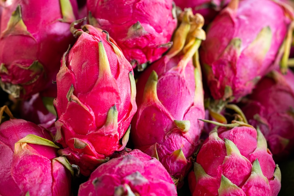 a pile of pink dragon fruit sitting on top of a table