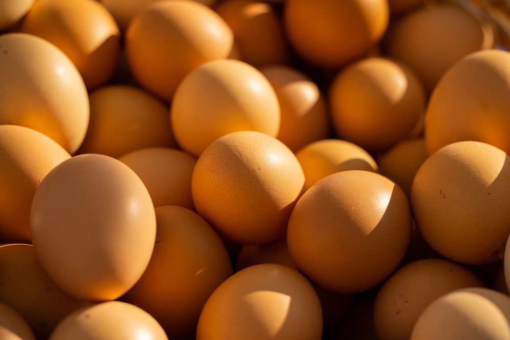 a bunch of brown eggs in a basket