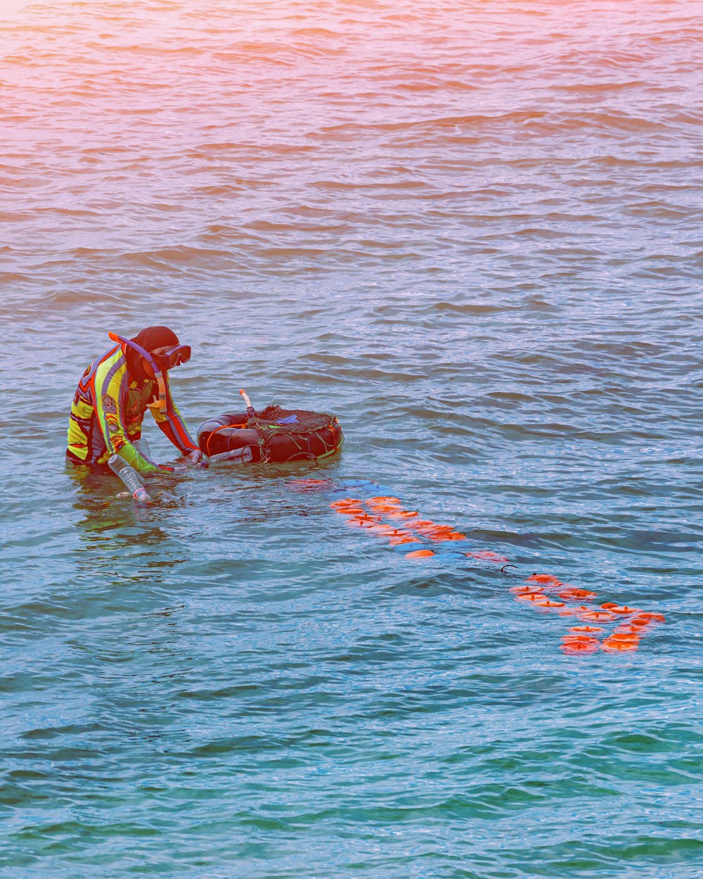 a man in a yellow vest is in the water