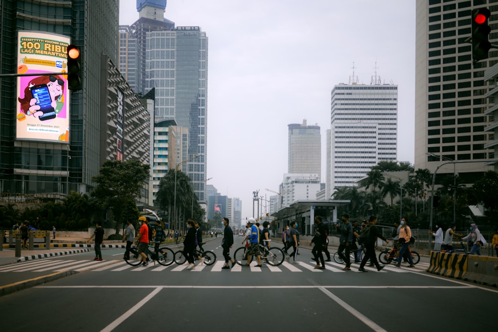 a group of people riding bikes across a street