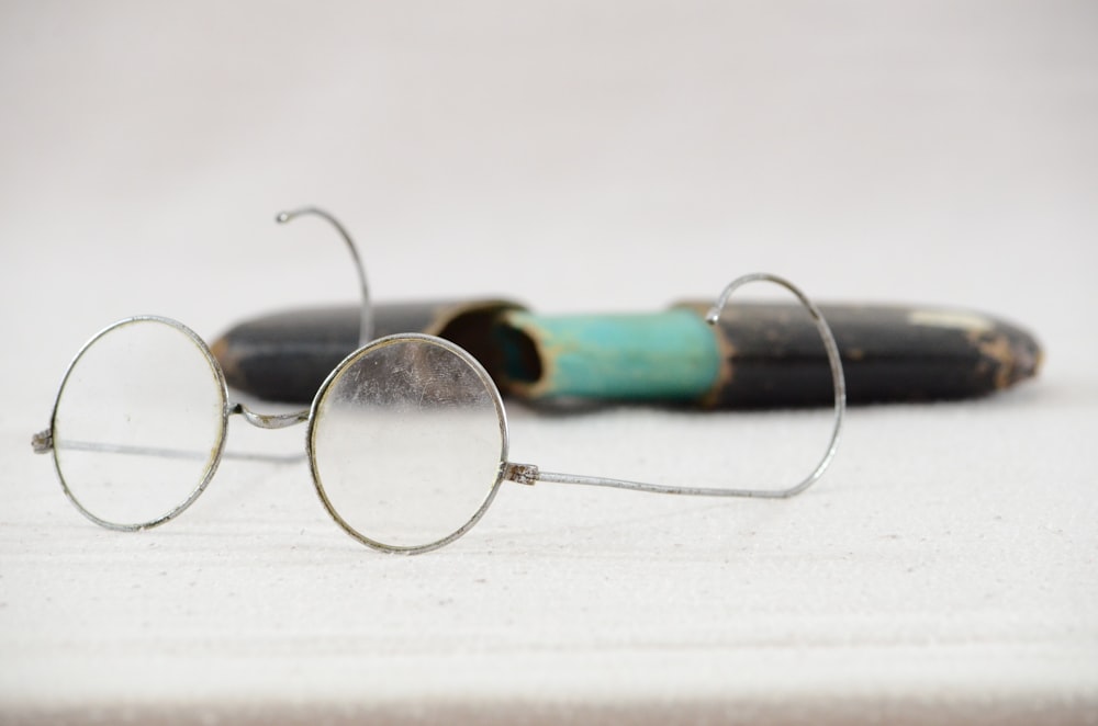 a pair of glasses sitting on top of a table