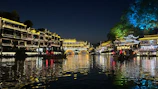 Evening view of the illuminated iki village towers reflecting on the river surface