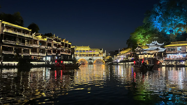 Evening view of the illuminated iki village towers reflecting on the river surface