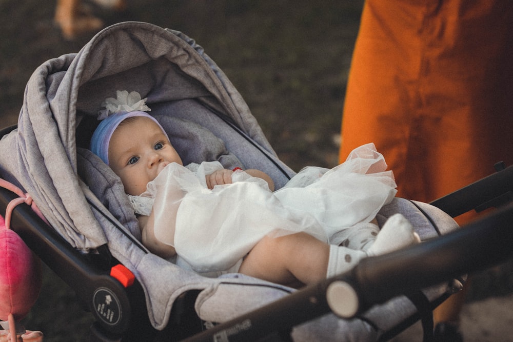 a baby is sitting in a stroller