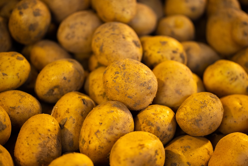 a pile of potatoes with brown spots on them