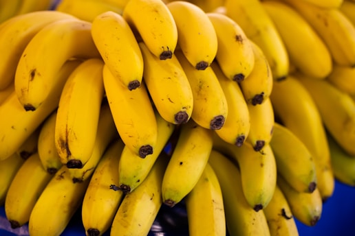 a bunch of bananas sitting on top of a blue table
