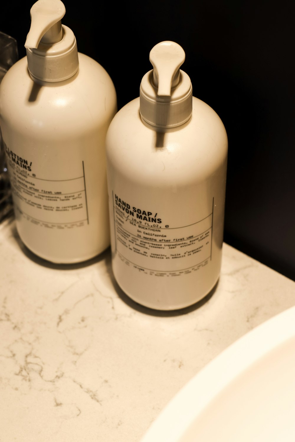 a couple of bottles sitting on top of a bathroom counter