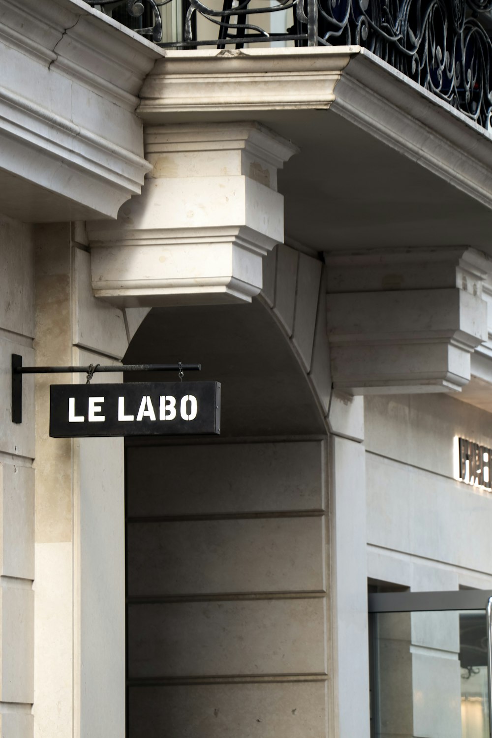 a street sign hanging from the side of a building