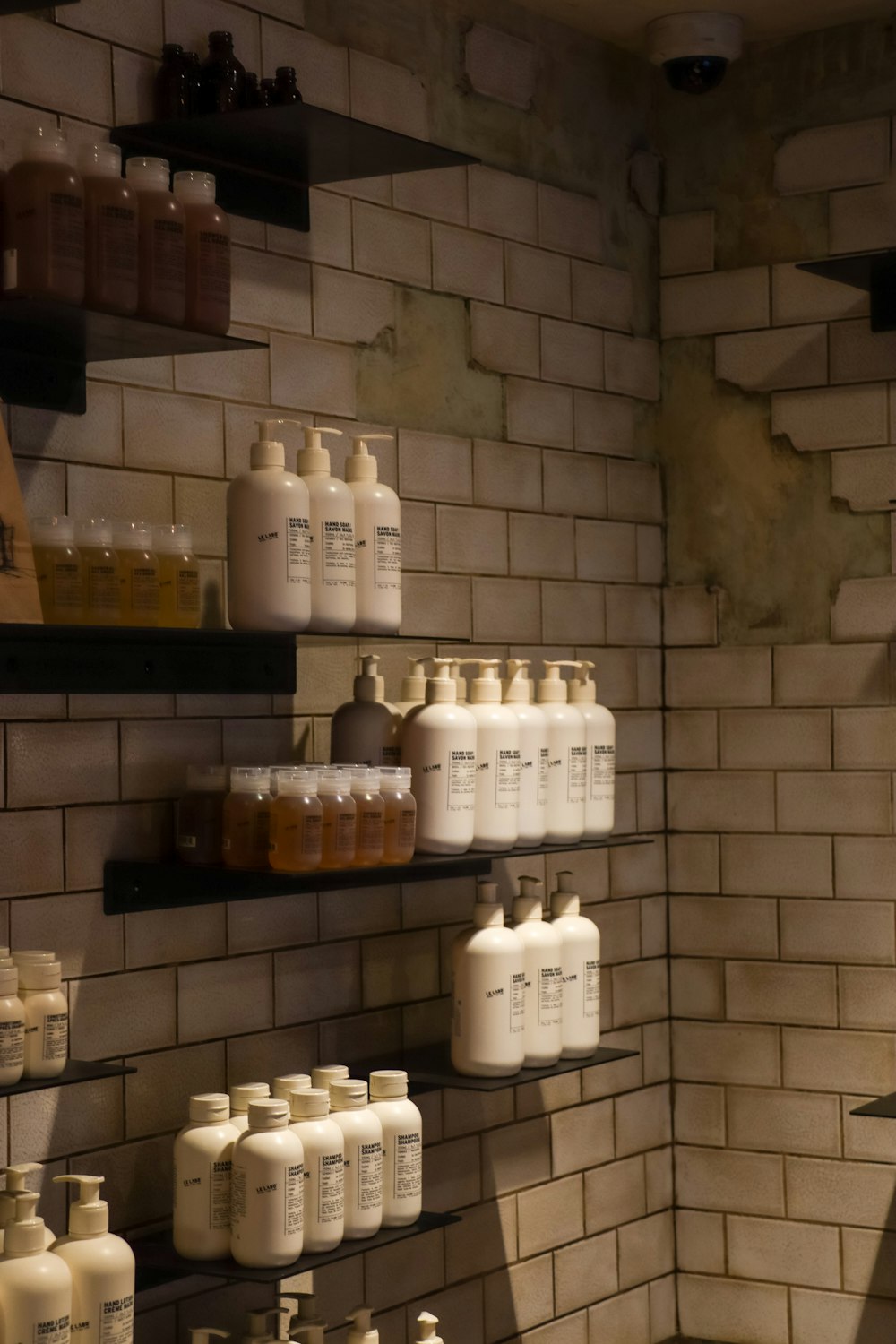 a shelf filled with lots of bottles of liquid