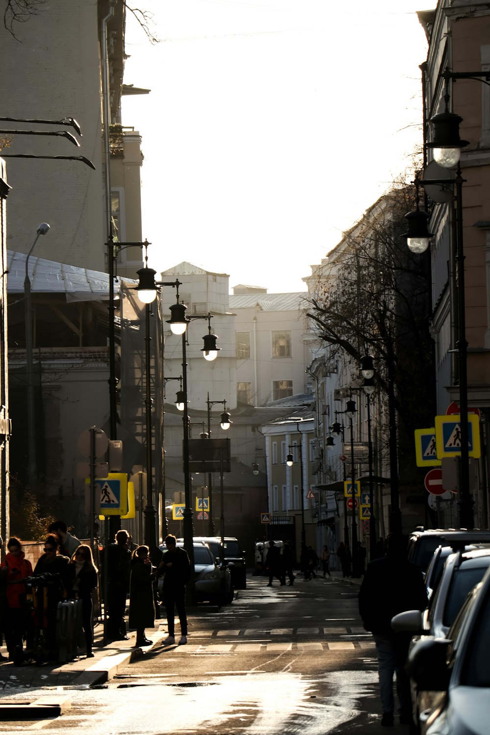 a group of people standing on the side of a street