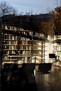 A peaceful reading area inside the Islamic institution's library with shelves of books and soft natural light.