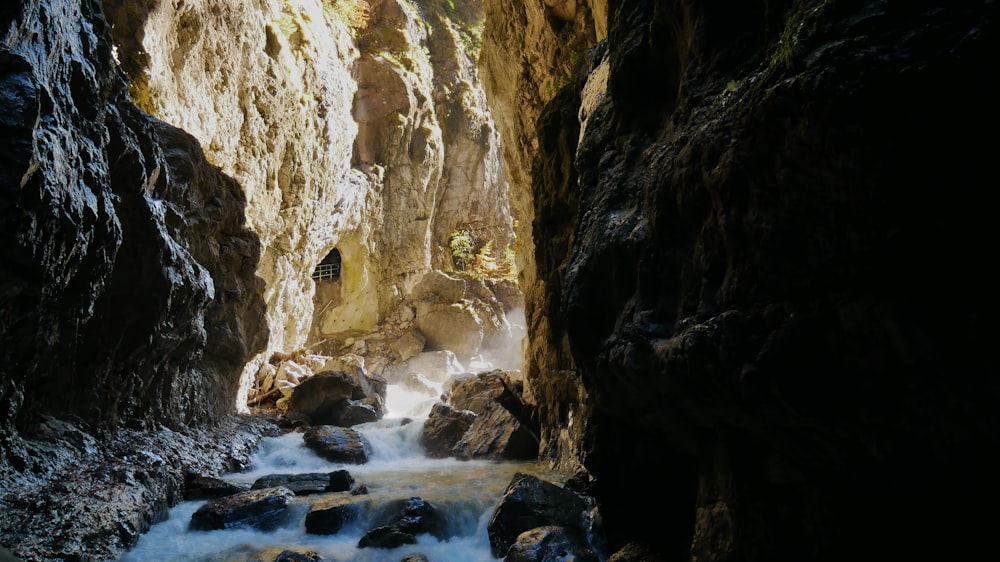 a stream running through a narrow rocky canyon