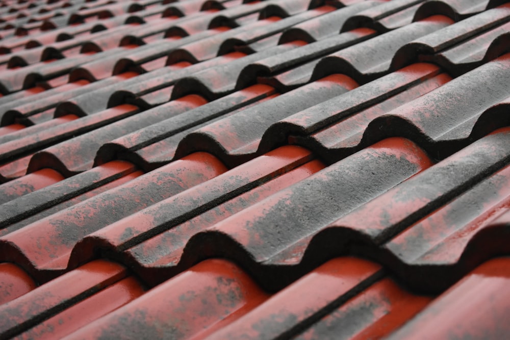 a close up of a roof with red tiles