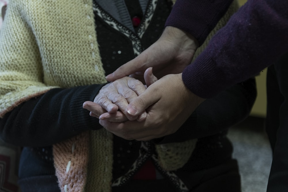 a group of people holding hands in a circle