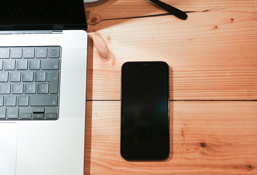 a laptop computer sitting on top of a wooden desk