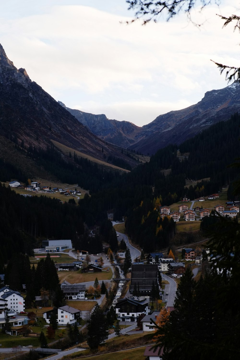 a scenic view of a town in the mountains