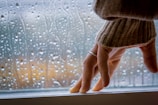 Artistic view of a hand gently wiping a window with a premium cloth.