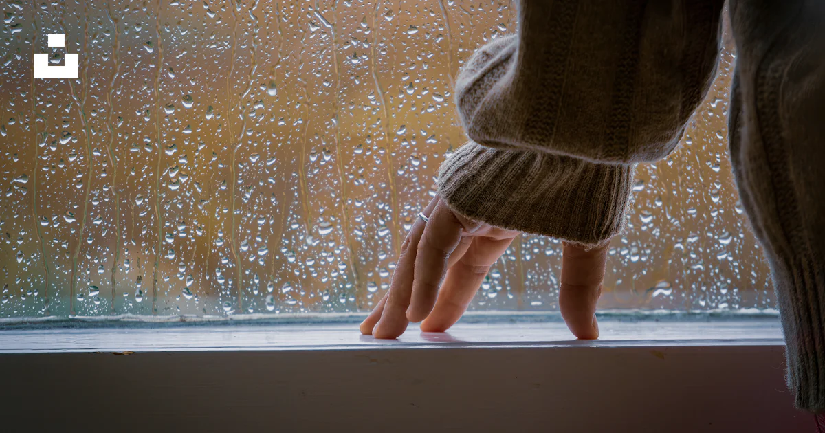 Window Sill Raining A person standing on a window sill in the rain photo – Free Hand Image ...