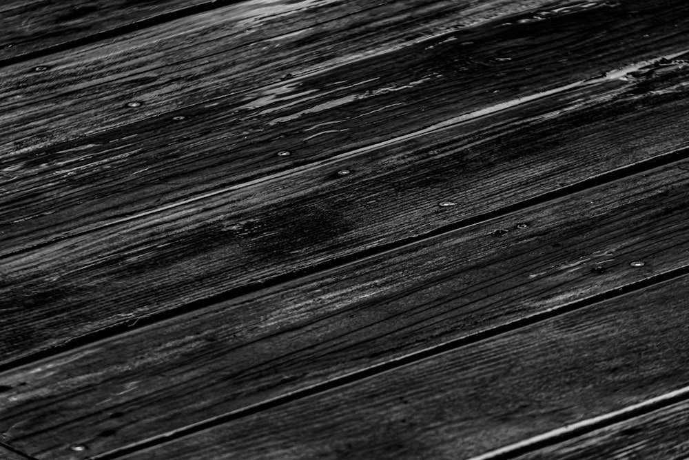 a black and white photo of a wooden floor