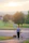 A young family walking their dog near the sandy beach area of River Park.