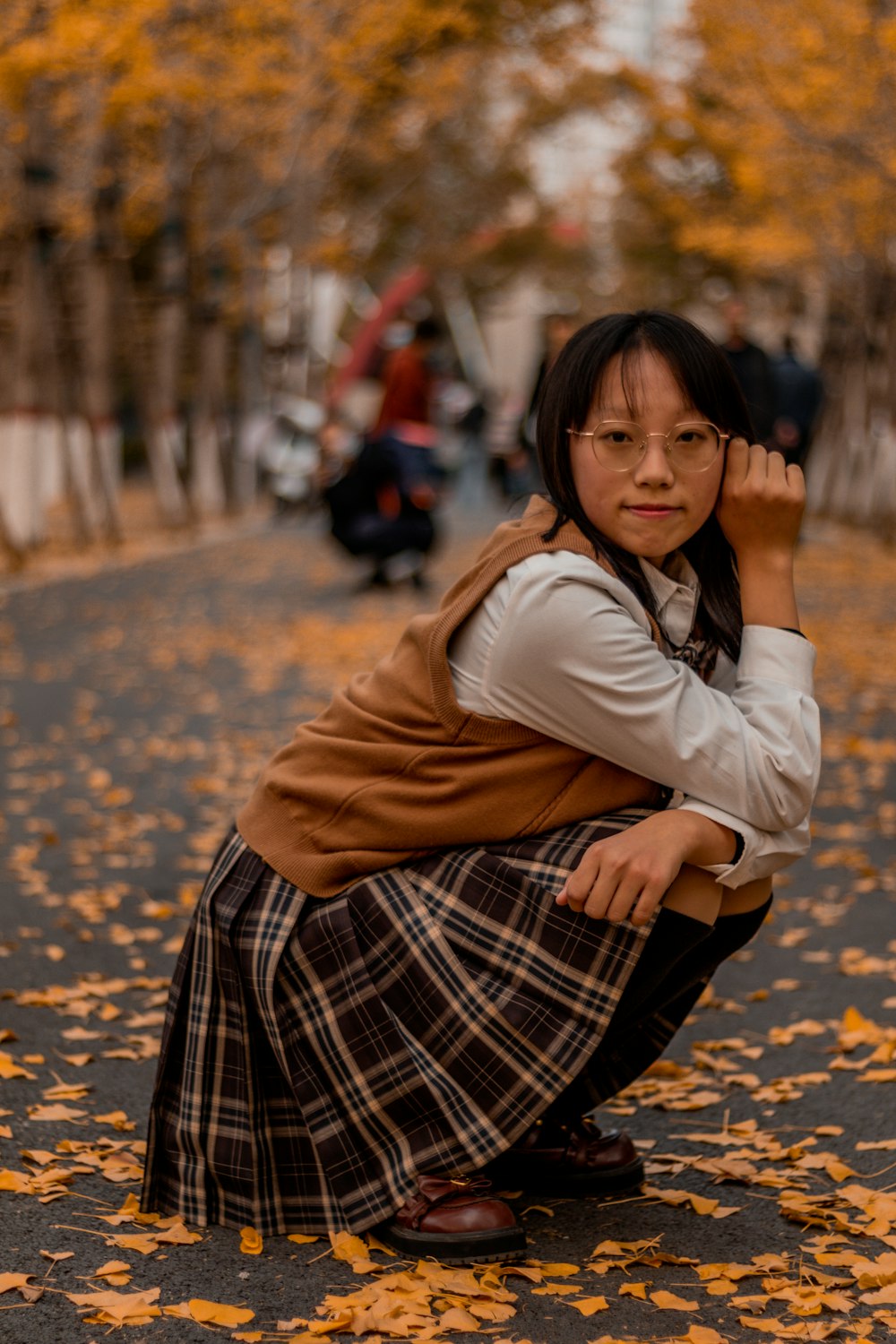 a woman kneeling on the ground with her arms crossed