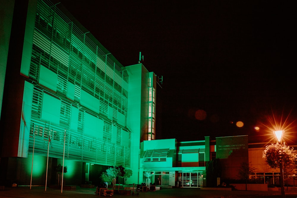 a building lit up with green lights at night