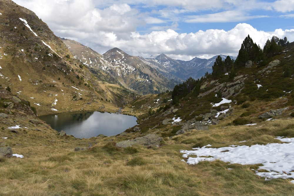 a small lake in the middle of a mountain range