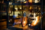 a display case with a variety of men's shoes