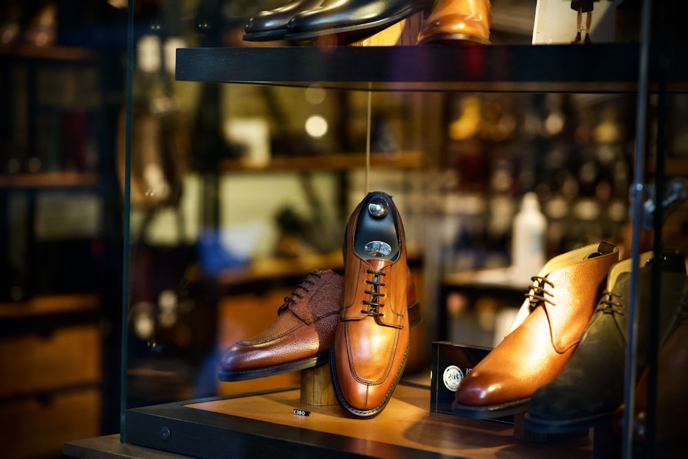 a display case with a variety of men's shoes