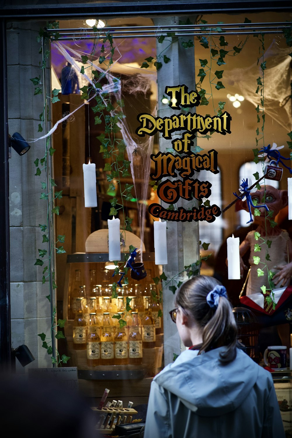 a woman standing in front of a store window