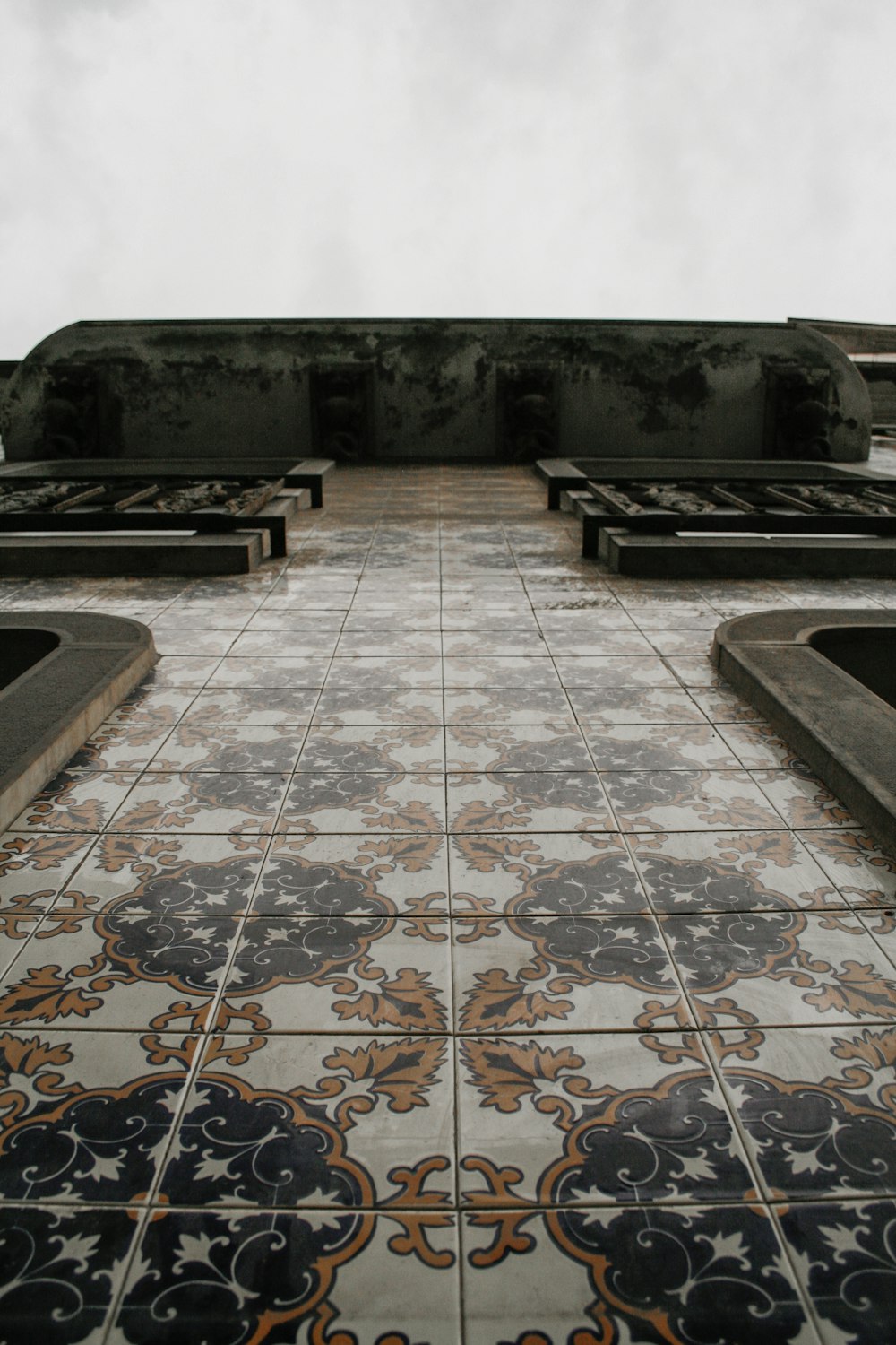 a bench sitting on top of a tiled floor
