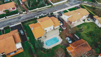 an aerial view of a house with a swimming pool