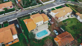 an aerial view of a house with a swimming pool