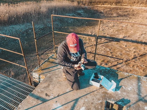 Technician inspecting drone parts in a workshop setting.