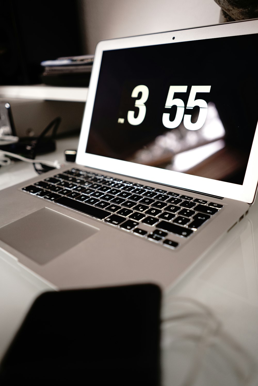 a laptop computer sitting on top of a white desk