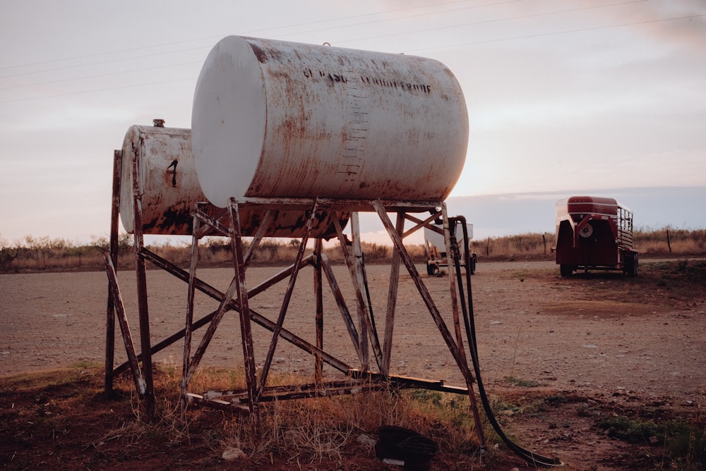 a large metal tank sitting on top of a wooden stand