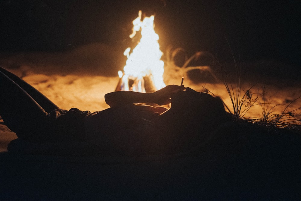 a person sitting in front of a fire