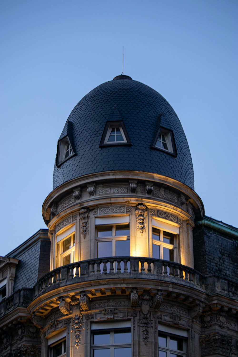 a round building with a blue roof and windows