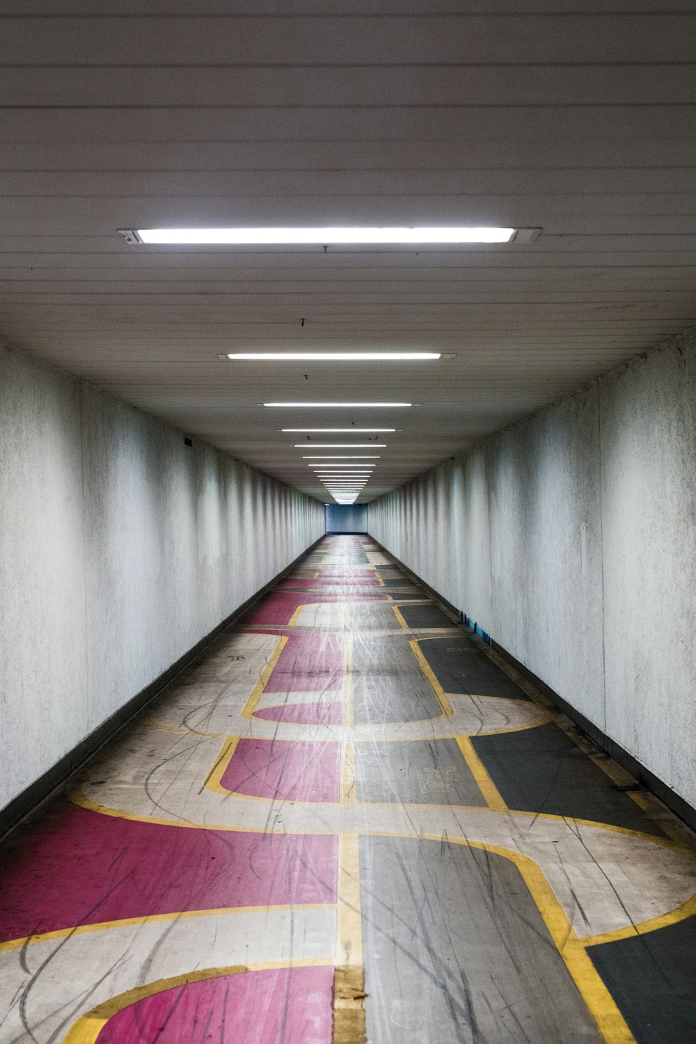 a long hallway with a colorful carpet on the floor