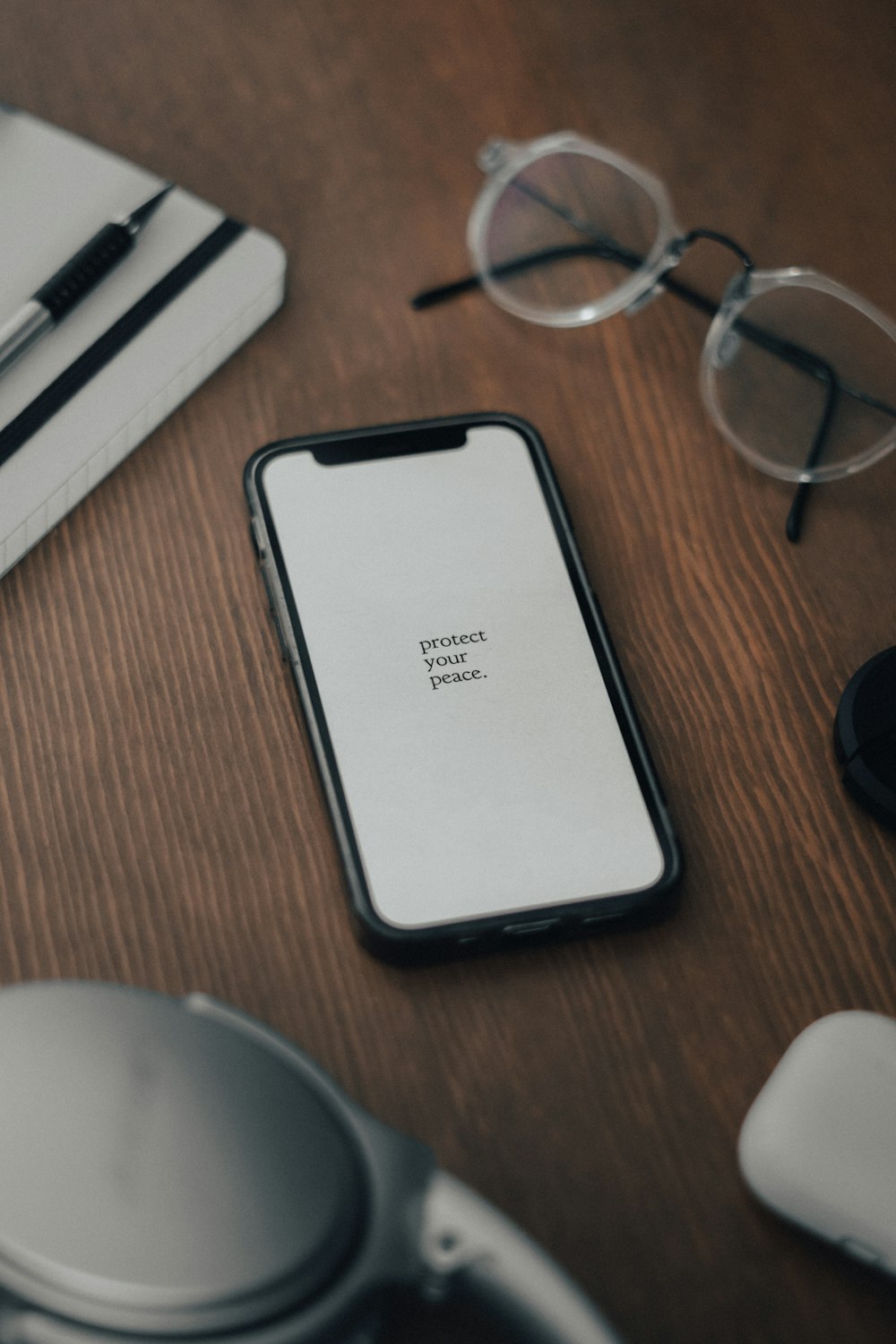 a cell phone sitting on top of a wooden table