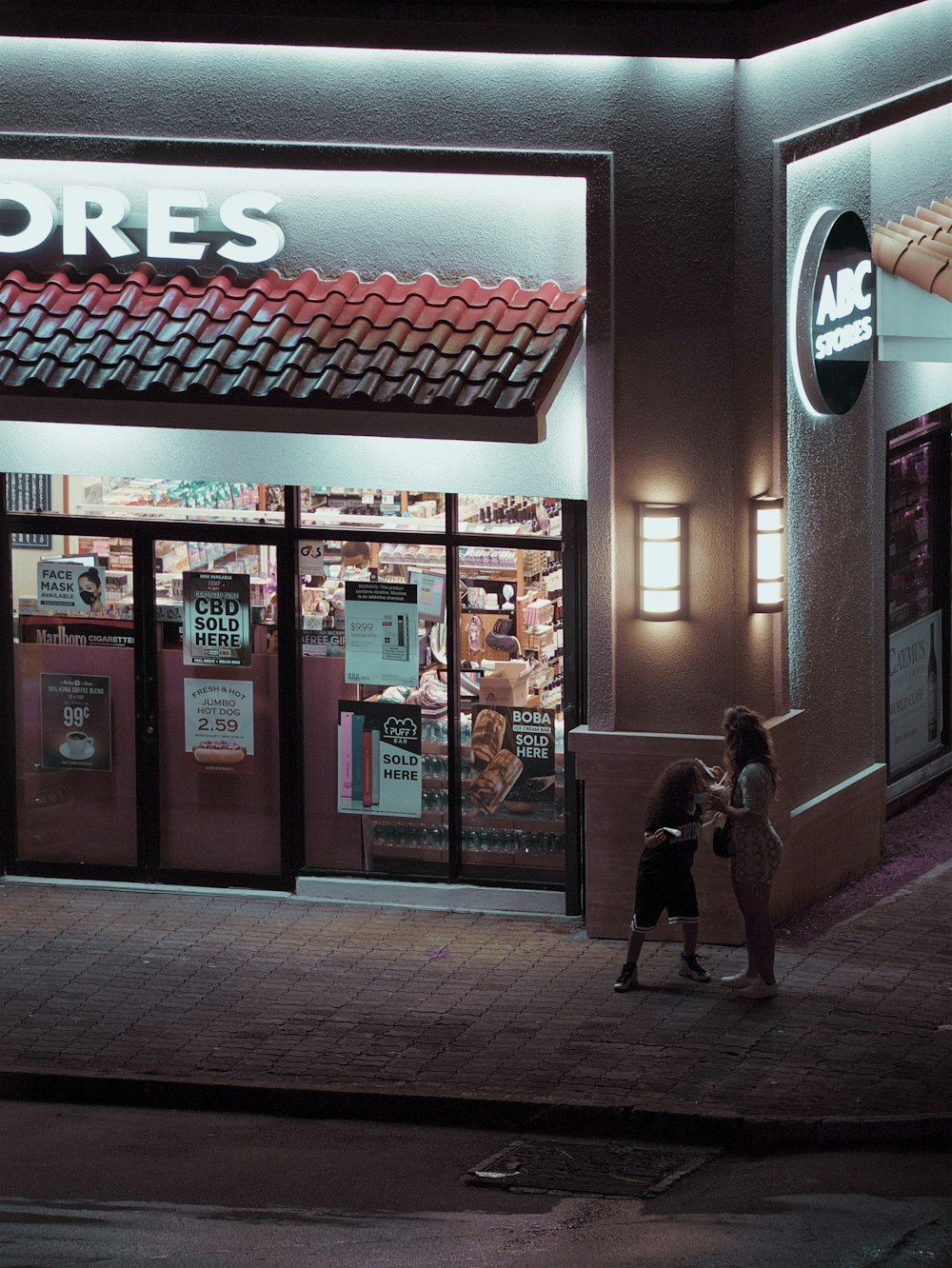 a couple of people standing outside of a store