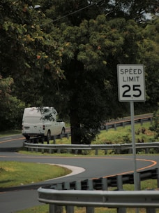 A comfortable van winding through lush Malaysian countryside roads.