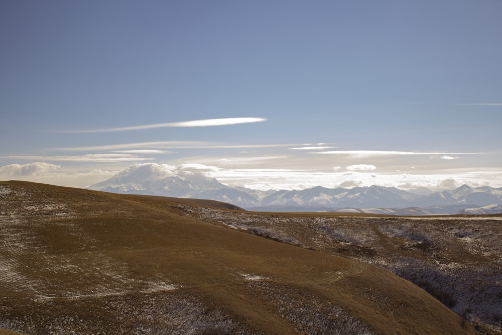 a view of the mountains from the top of a hill