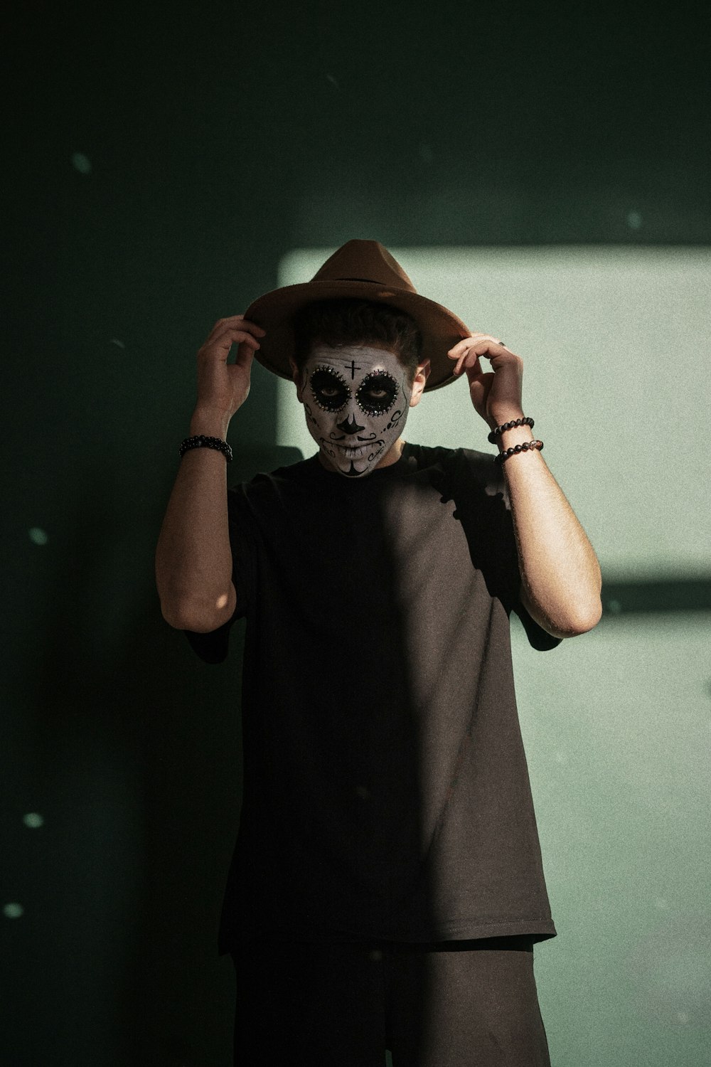 a man wearing a skeleton mask and a hat