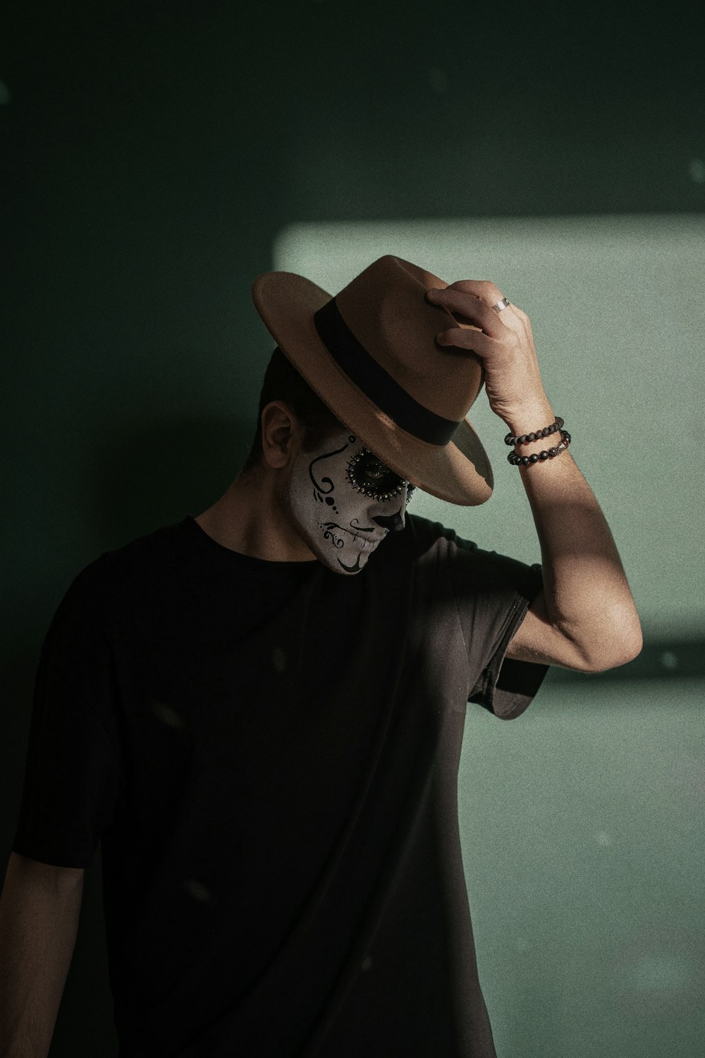 a man wearing a hat and a face paint