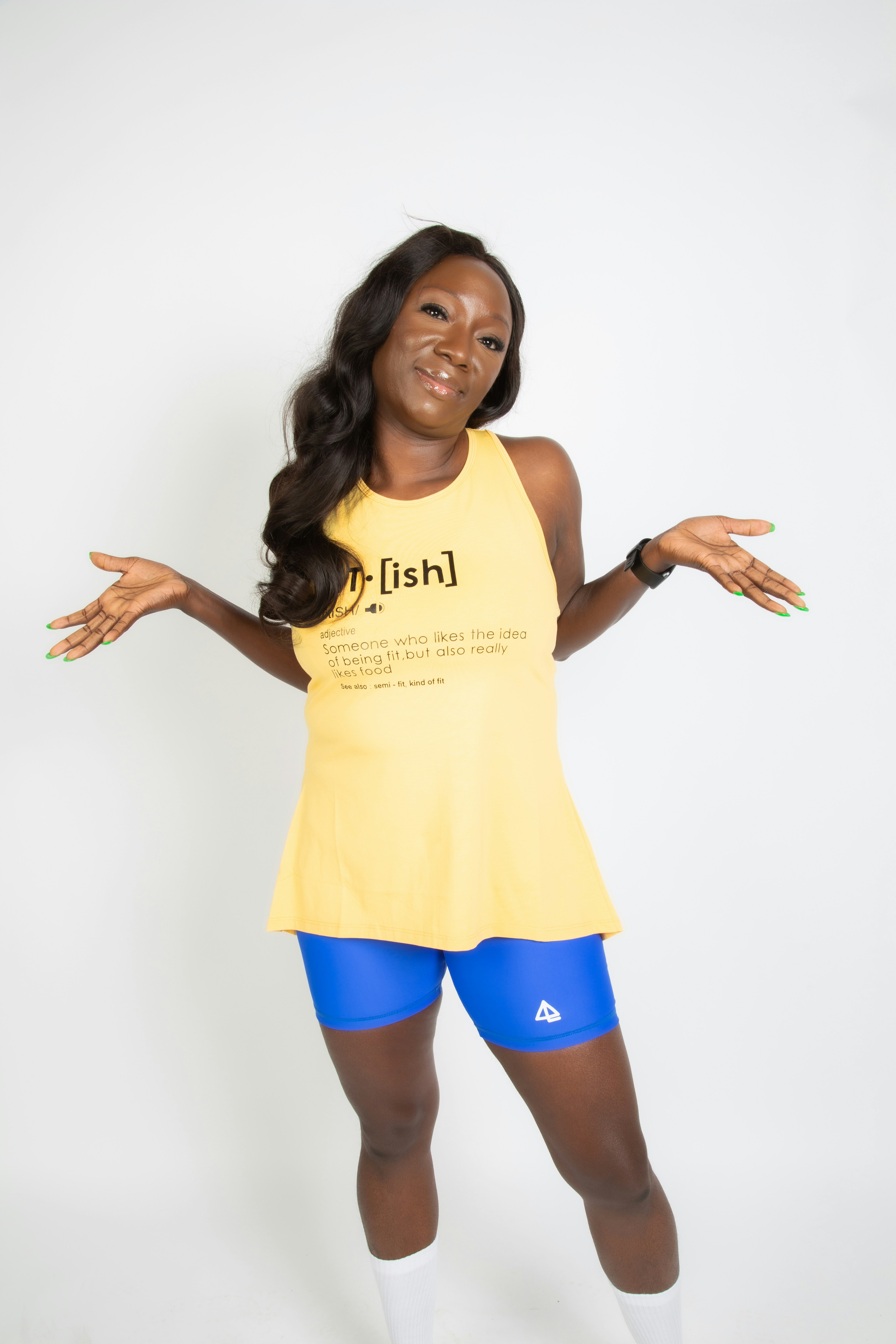 a woman in a yellow shirt and blue shorts