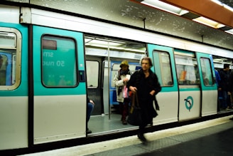 a group of people standing next to a train