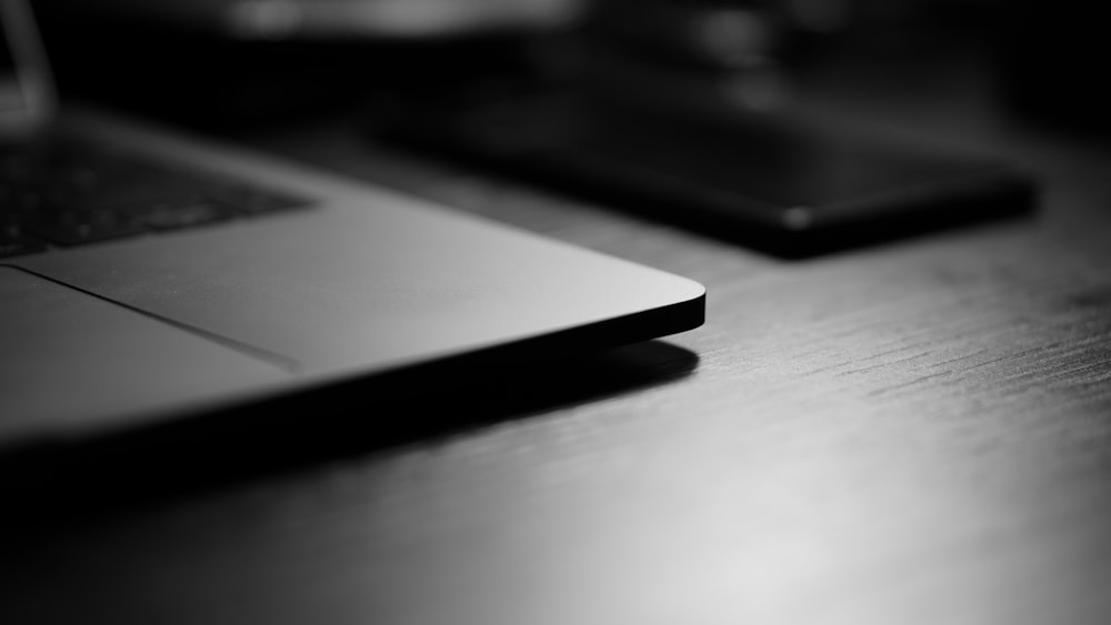 a laptop computer sitting on top of a wooden desk